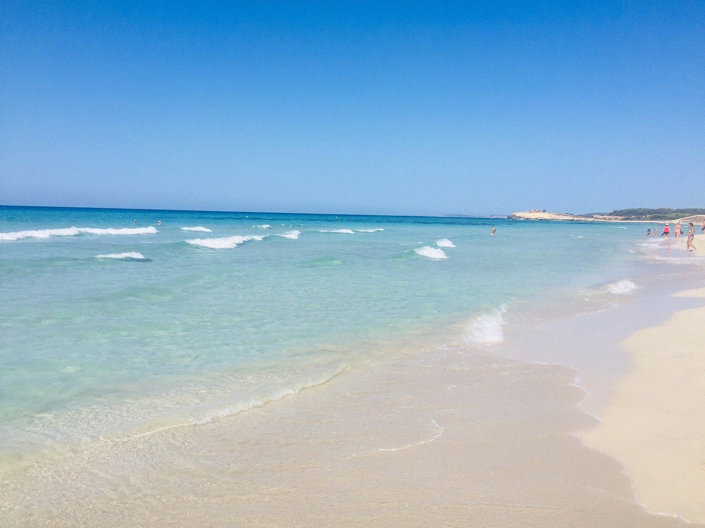 Waves rolling onto white sand