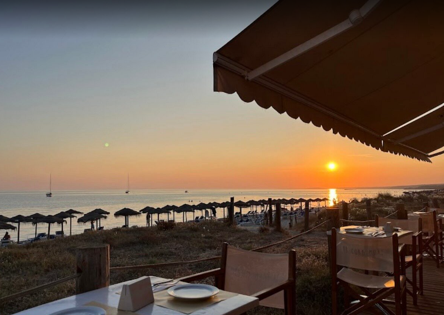 Sunset over Son Bou beach seen from a beachside restaurant terrace
