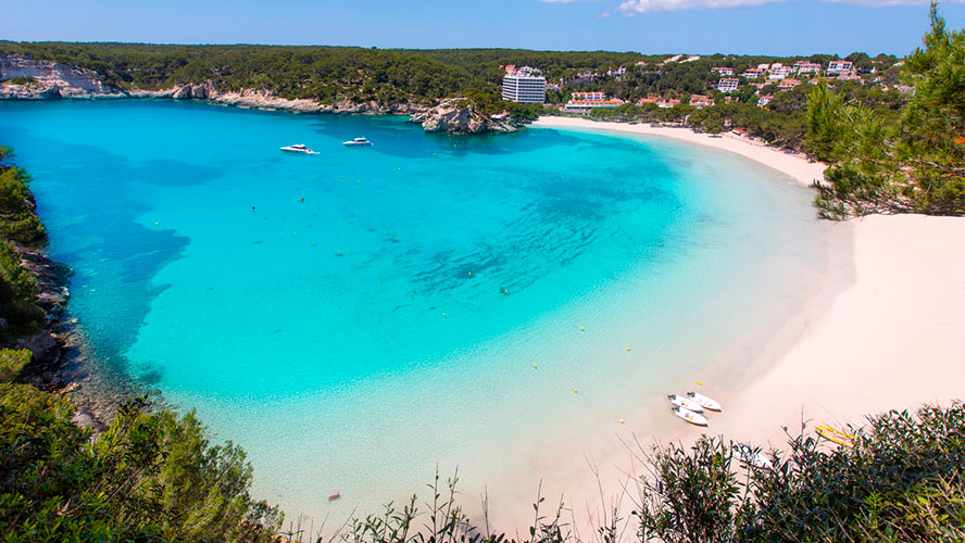 Cala Galdana beach, a wide sandy cove with turquoise water