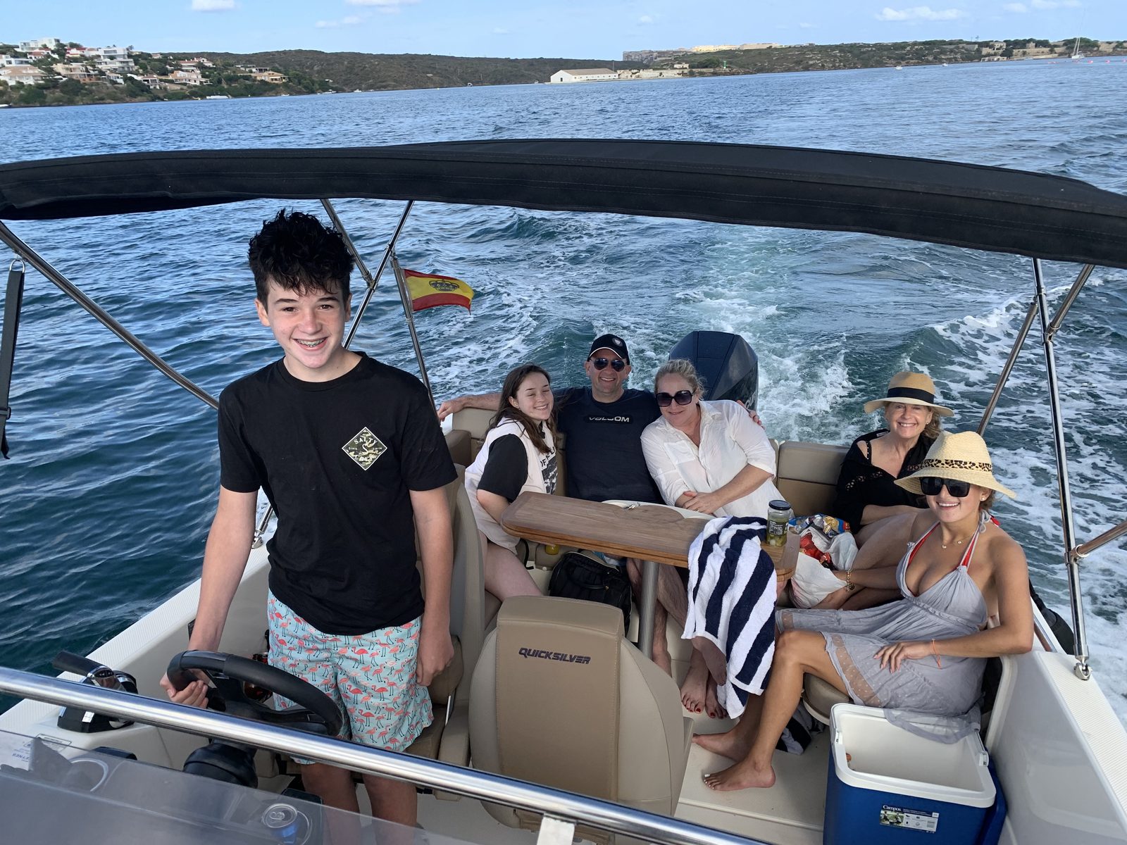 Family aboard the boat, Spanish flag flying