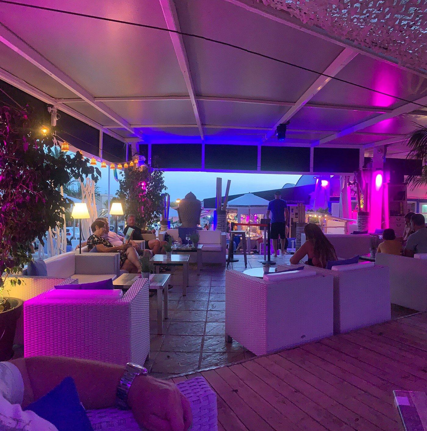 Buddha Lounge's purple-lit terrace at dusk