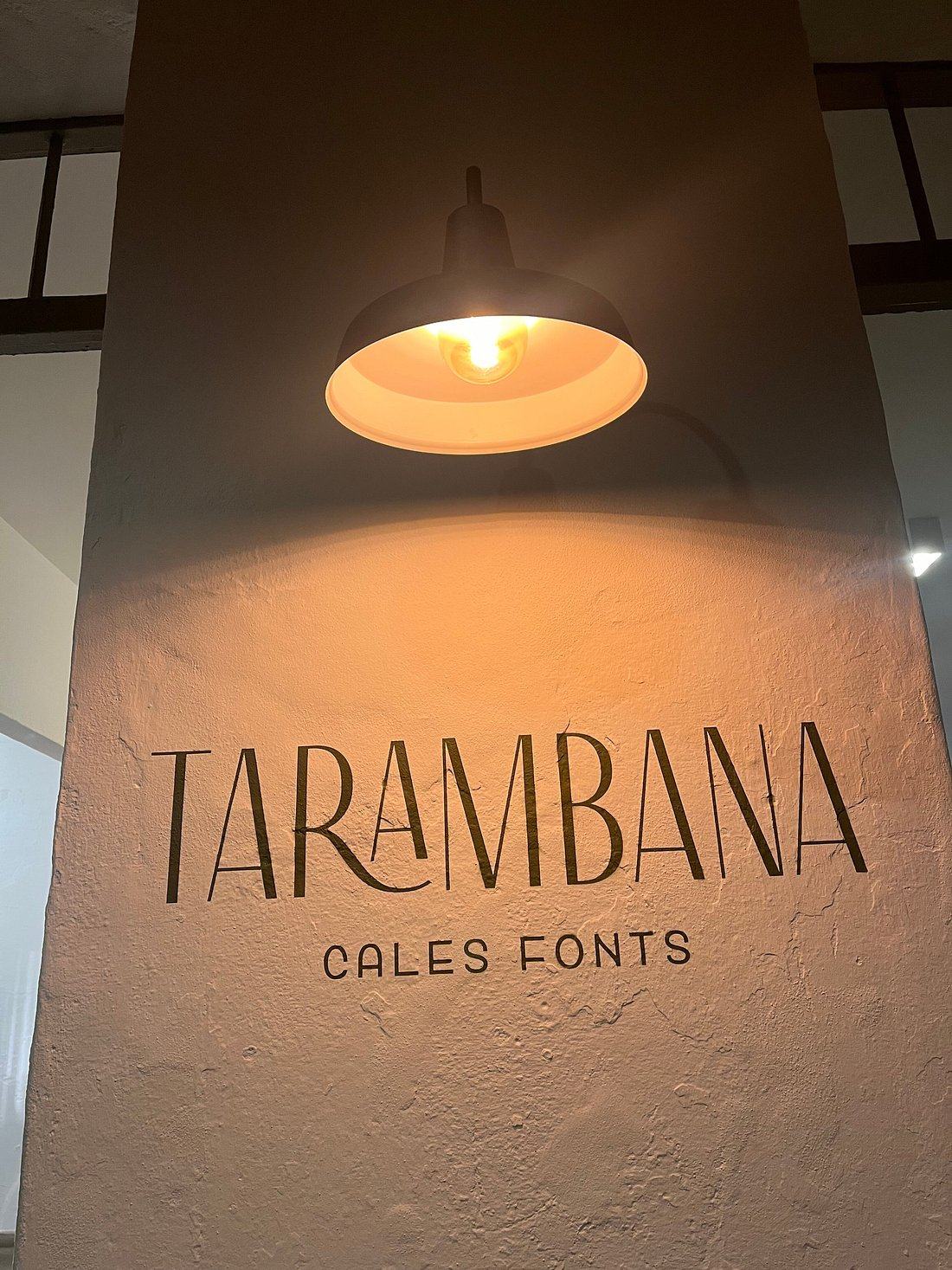 The Tarambana sign lit above a stone pillar