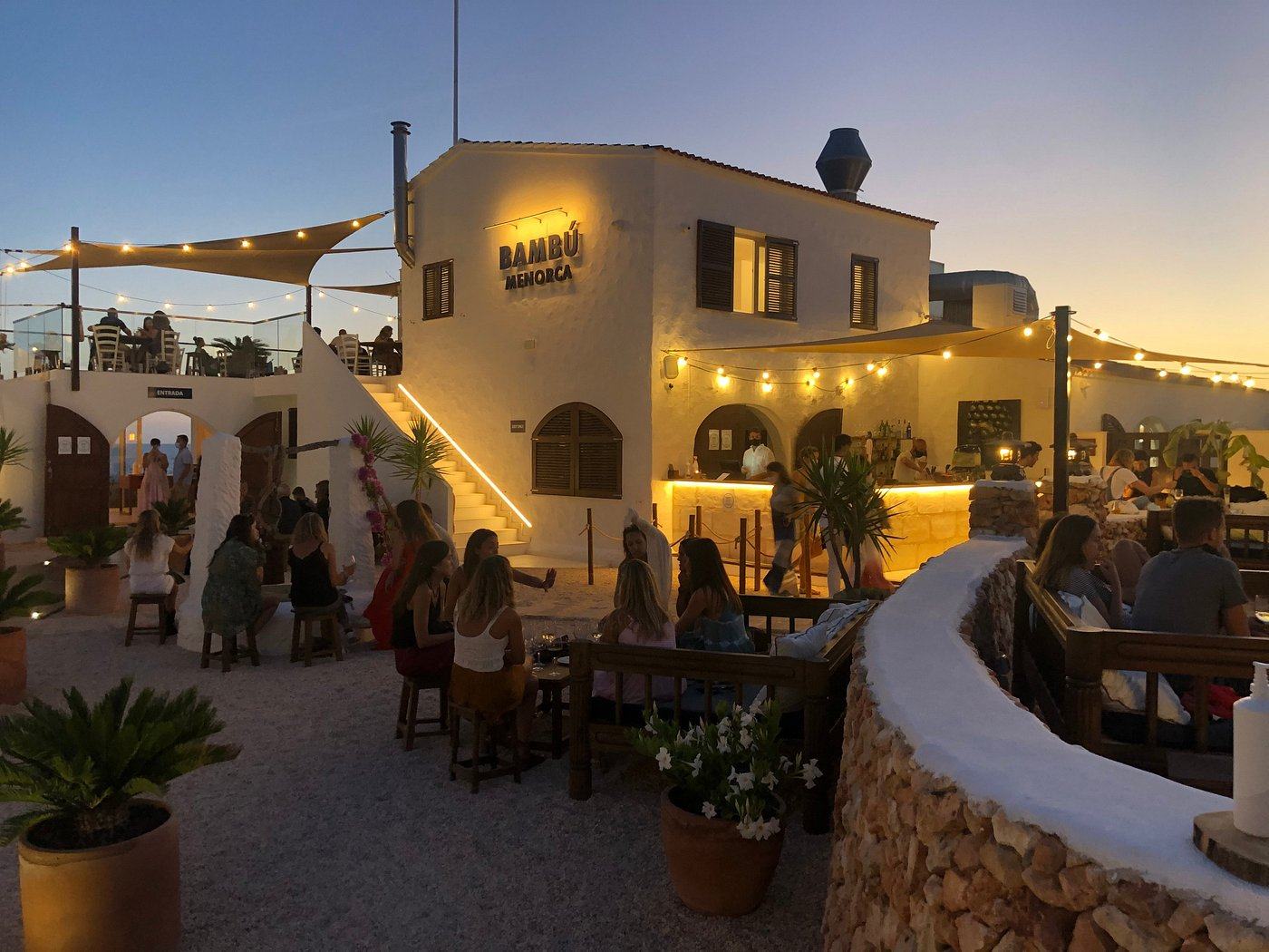 Bambú Menorca lit up at dusk