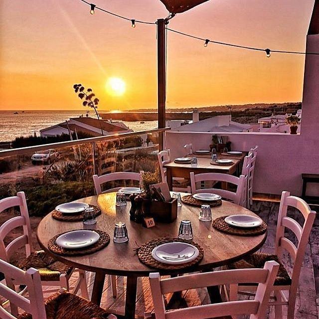 A rooftop table set for dinner