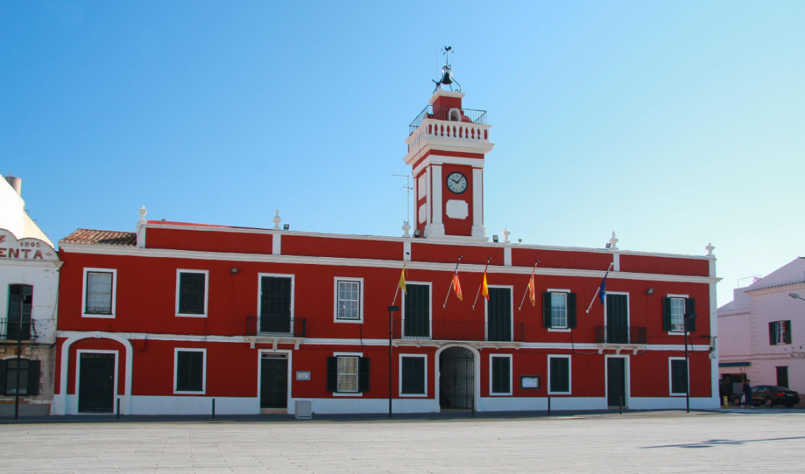 The red-painted former British barracks building on the Parade Square in Es Castell