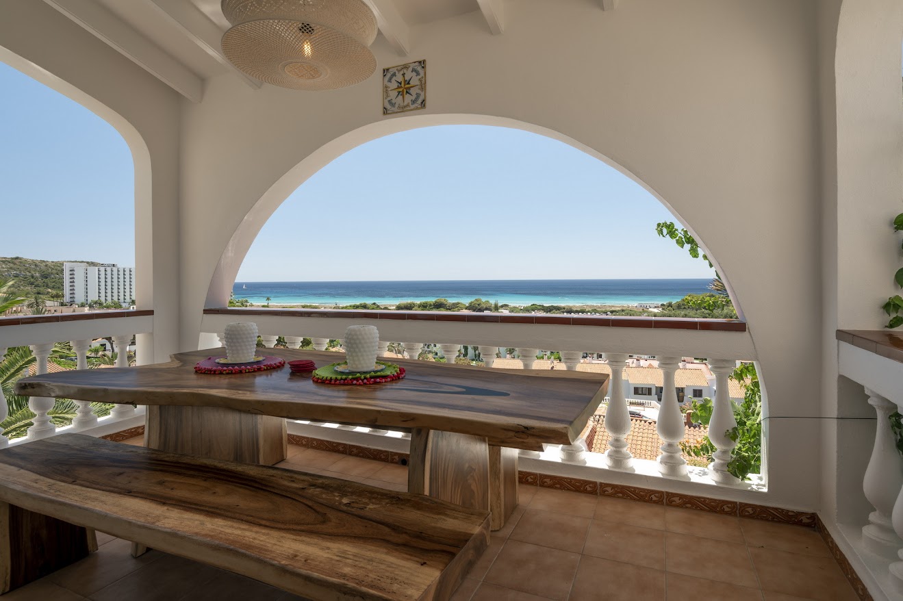 Villa dining terrace under an arch, sea view beyond