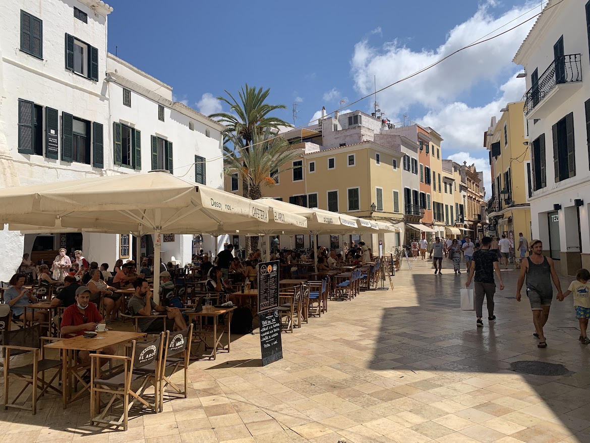 Café tables along a Ciutadella street