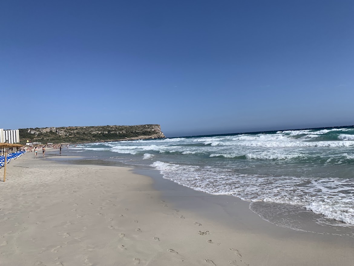 Waves rolling onto a wide sandy beach