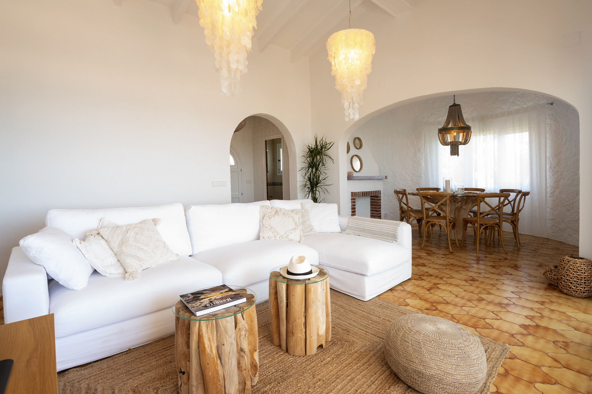 Open living and dining area with vaulted beamed ceilings