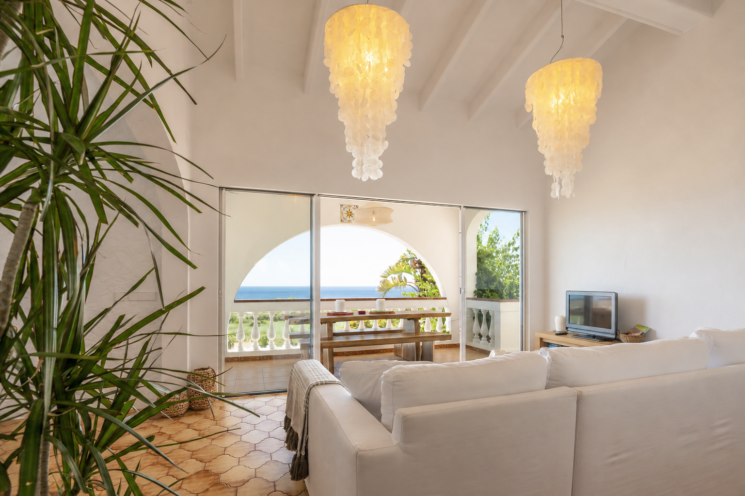 Living room with sea-view terrace and pendant lights