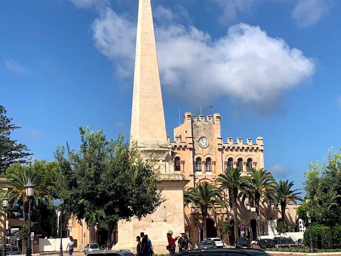 The obelisk and neo-Gothic town hall tower in Maó