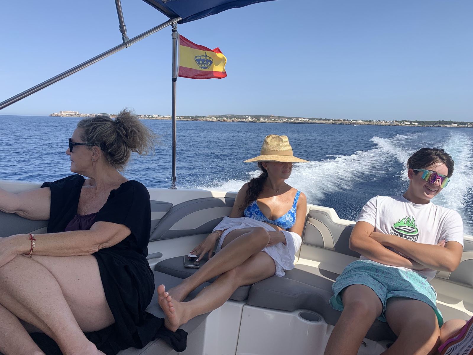 Family aboard the boat, Spanish flag flying