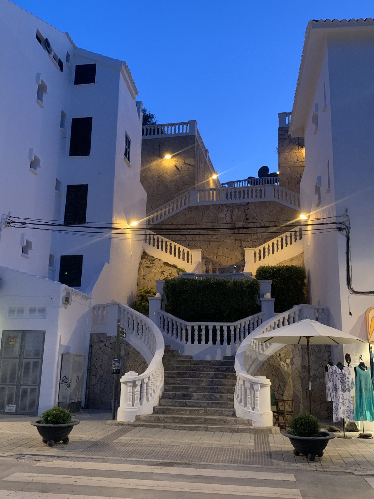 Grand staircases leading down toward Maó's harbour at dusk