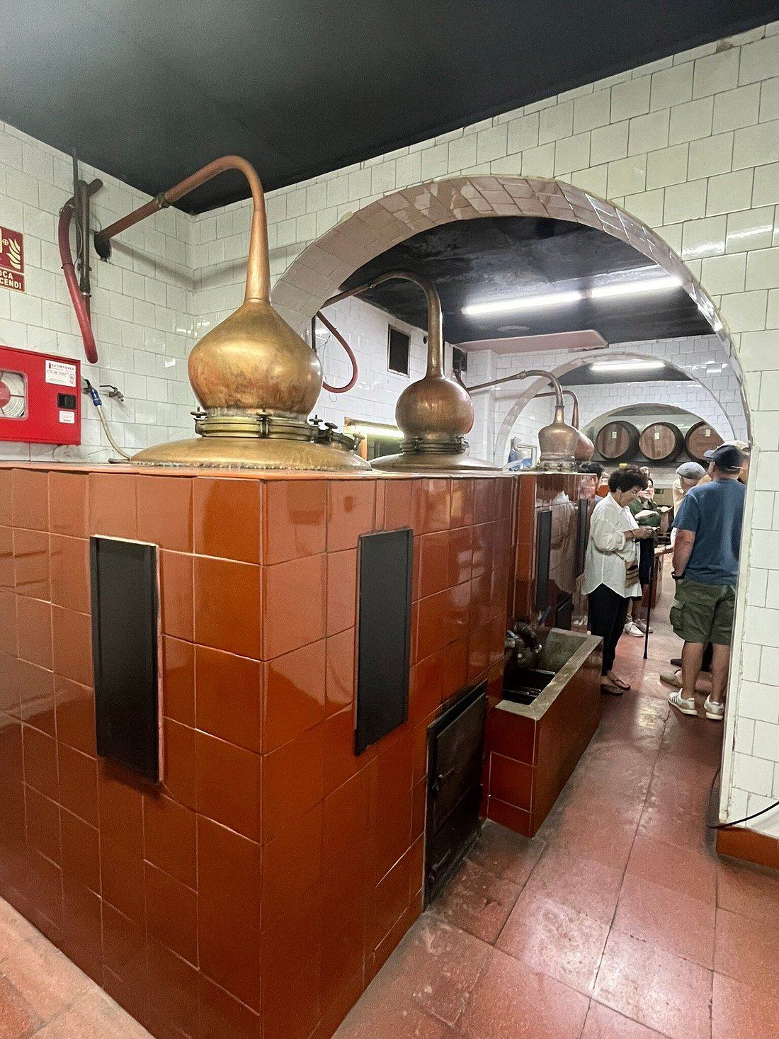 Visitors touring the copper pot stills